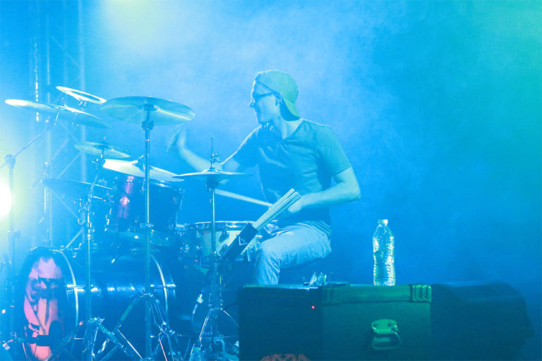 Cody playing the drums on stage