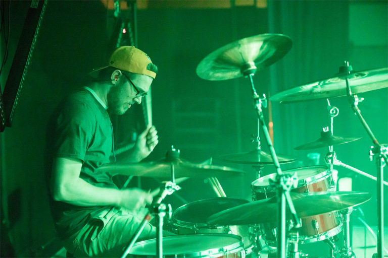 Cody playing the drums on stage